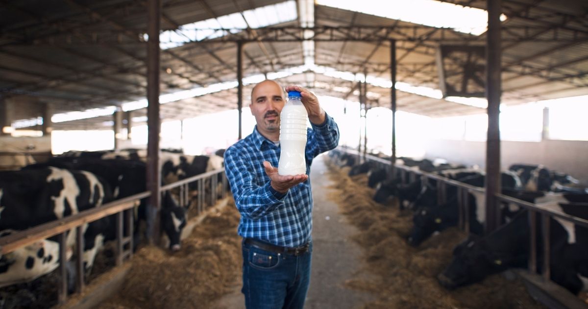 Imagem de homem segurando garrafa de leite